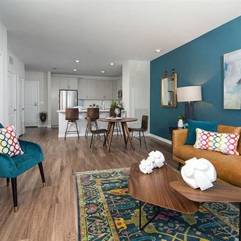 Beautiful wood grain flooring flows through kitchen and living areas